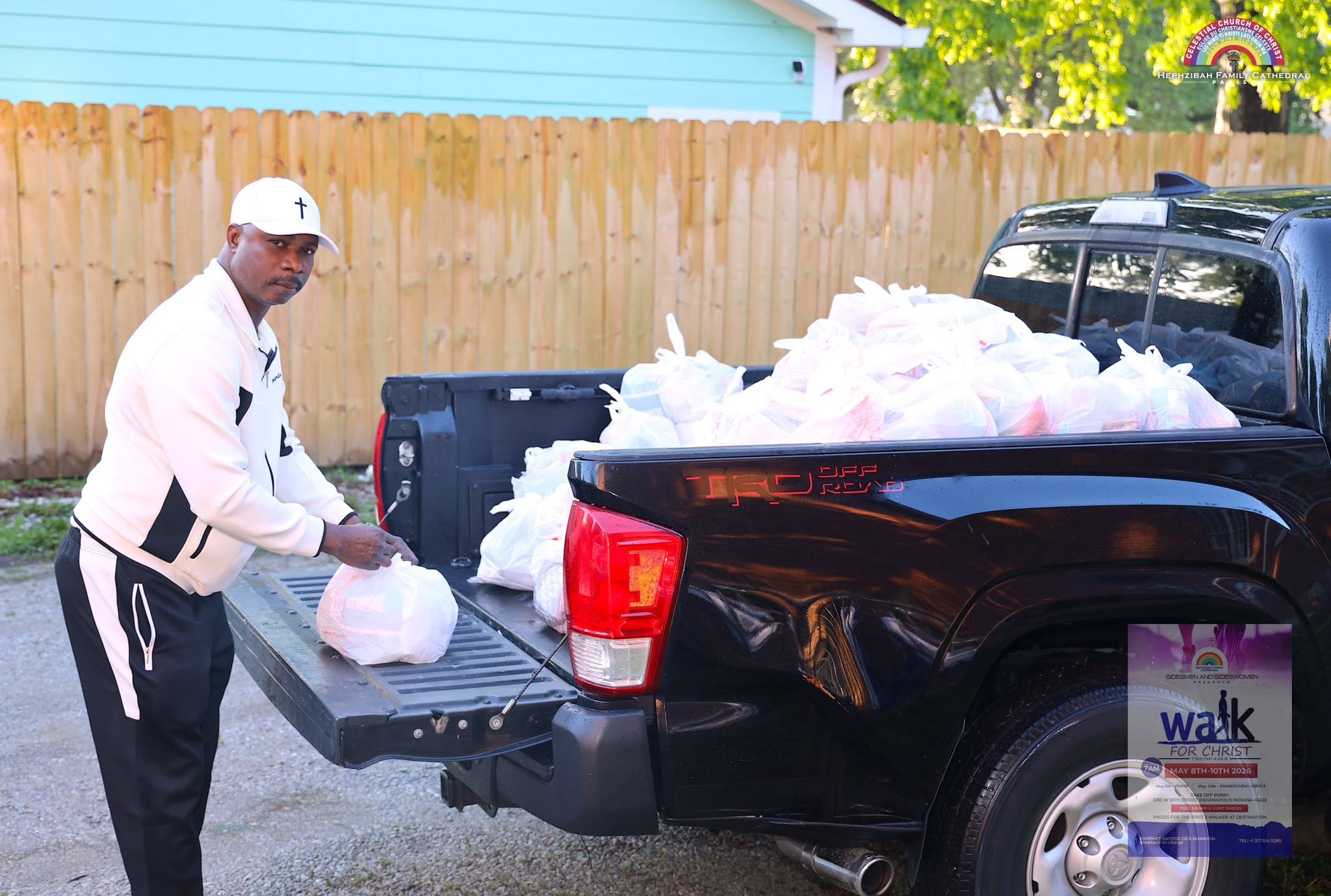 Volunteers gathered beside a vehicle during outreach distribution